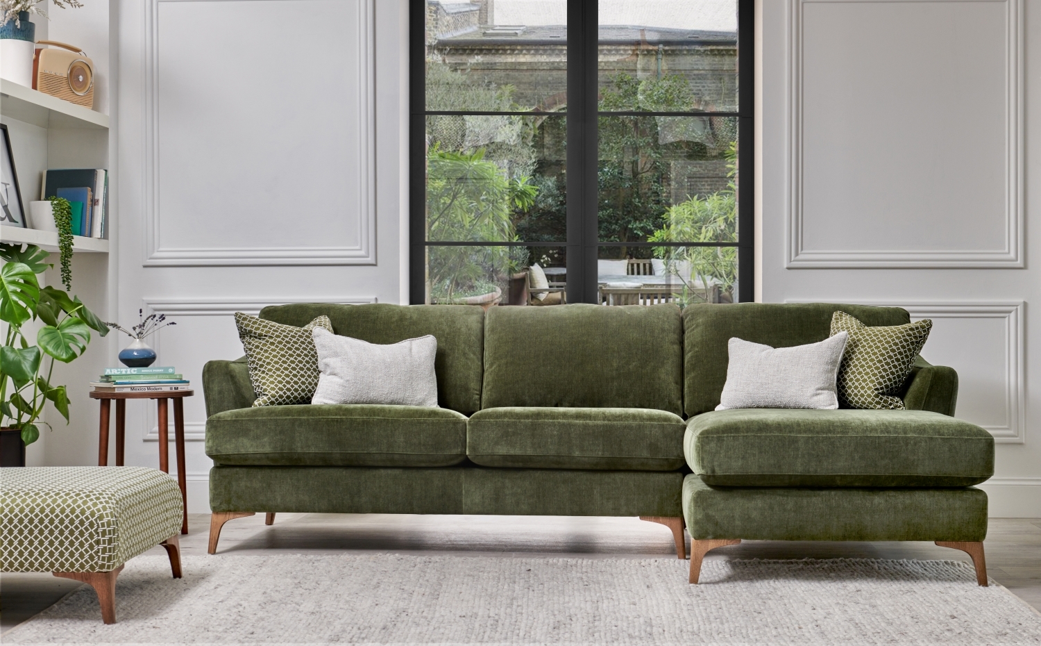 sage green fabric sofa with chaise and scatter cushions in natural colours room